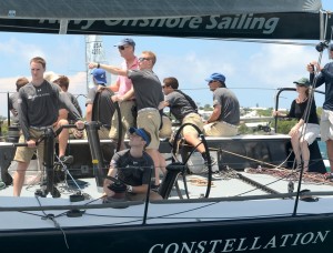 During the 2014 RBYC Anniversary Regatta, the youthful sailors in the Naval Academy's Constellation trim sheets while Skipper Josh Forgacs advises the helmsman, Bermuda Governor George Fergusson. (Talbot Wilson.PPL) PHOTO CREDIT: Talbot Wilson/PPL Tel: +44(0)1243 555561 E.mail: ppl@mistral.co.uk web: www.pplmedia.com ***2014 Royal Bermuda YC Anniversary Regatta: CONSTELLATION skippered by Joshua Forgacs. His Excellency the Governor of Bermuda Mr. George Fergusson sailed in the spectacular racing in the 2014 Royal Bermuda Yacht Club Anniversary Regatta, the final stage of the Onion Patch Series and the new Navigators Race Series. The series also included the New York YC Annual Regatta presented by Rolex and the Newport Bermuda Race. Mr. Fergusson was at the helm of the US Naval Academy 's Constellation for the final leg in Hamilton Harbour.Skipper Midshipman Josh Forgacs points the way to the finish.