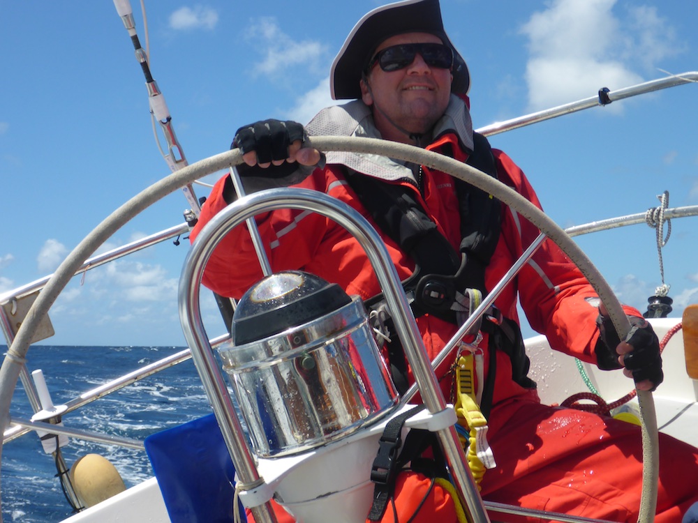 Steering offshore sailboat in sunny conditions