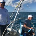 Merlin’s Path: A Strong Grip on the Wheel Rear Admiral Bill Merlin steers the yacht Merlin across the finish line in Bermuda