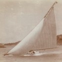 A fitted dinghy slices by St. David's Island in 1920. (National Museum of Bermuda)