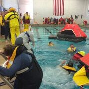 Willing victims go into the pool and crowded liferafts at the 2016 "gut check" Storm Trysail seminar at Fort Schuyler. 