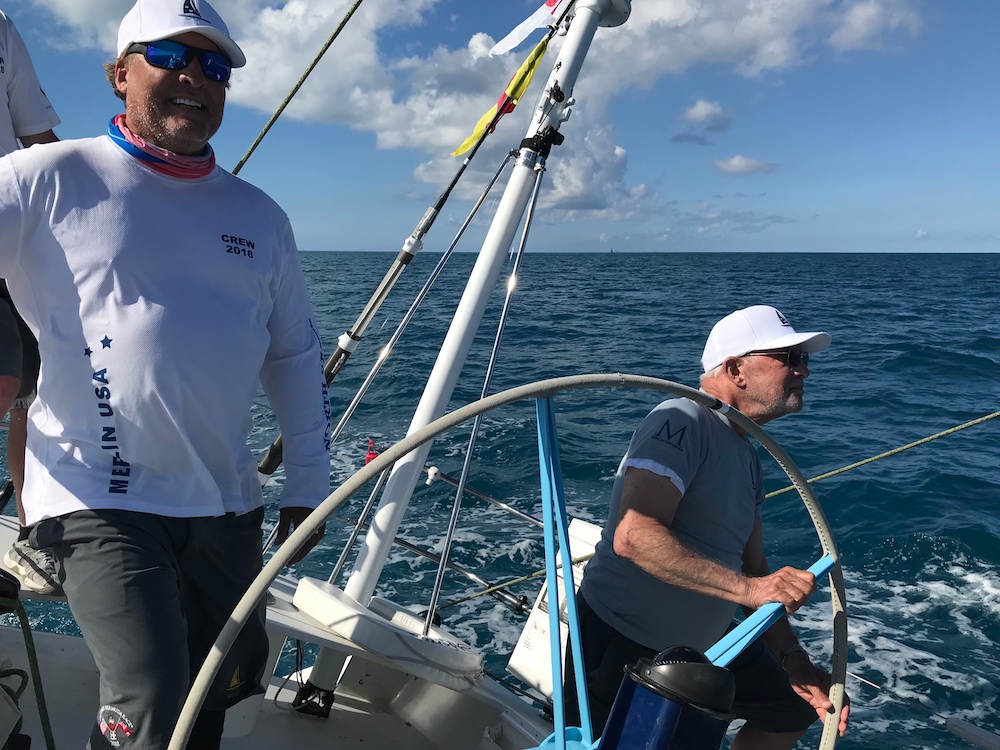 Rear Admiral Bill Merlin steers the yacht Merlin across the finish line in Bermuda